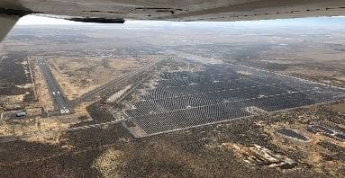 An aerial view of a large field with lots of trees.