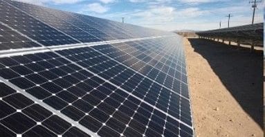 A large solar panel sitting on top of a field.