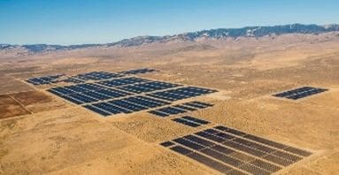 A large field of solar panels in the middle of nowhere.