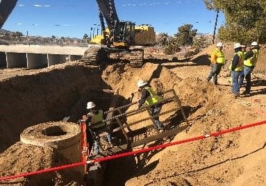 A group of people working on the side of a road.