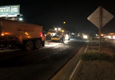 A truck is parked on the side of the road.