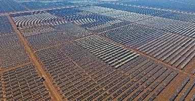 A large field of solar panels in the middle of nowhere.