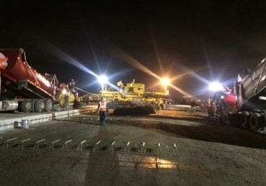 A group of people standing around in the dark.