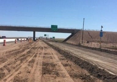 A road with dirt and grass on it