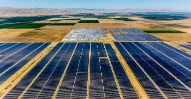 A large field of solar panels in the middle of nowhere.