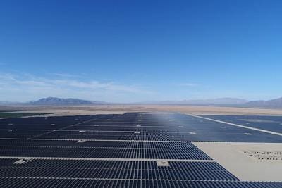 A large solar panel sitting on top of an open field.